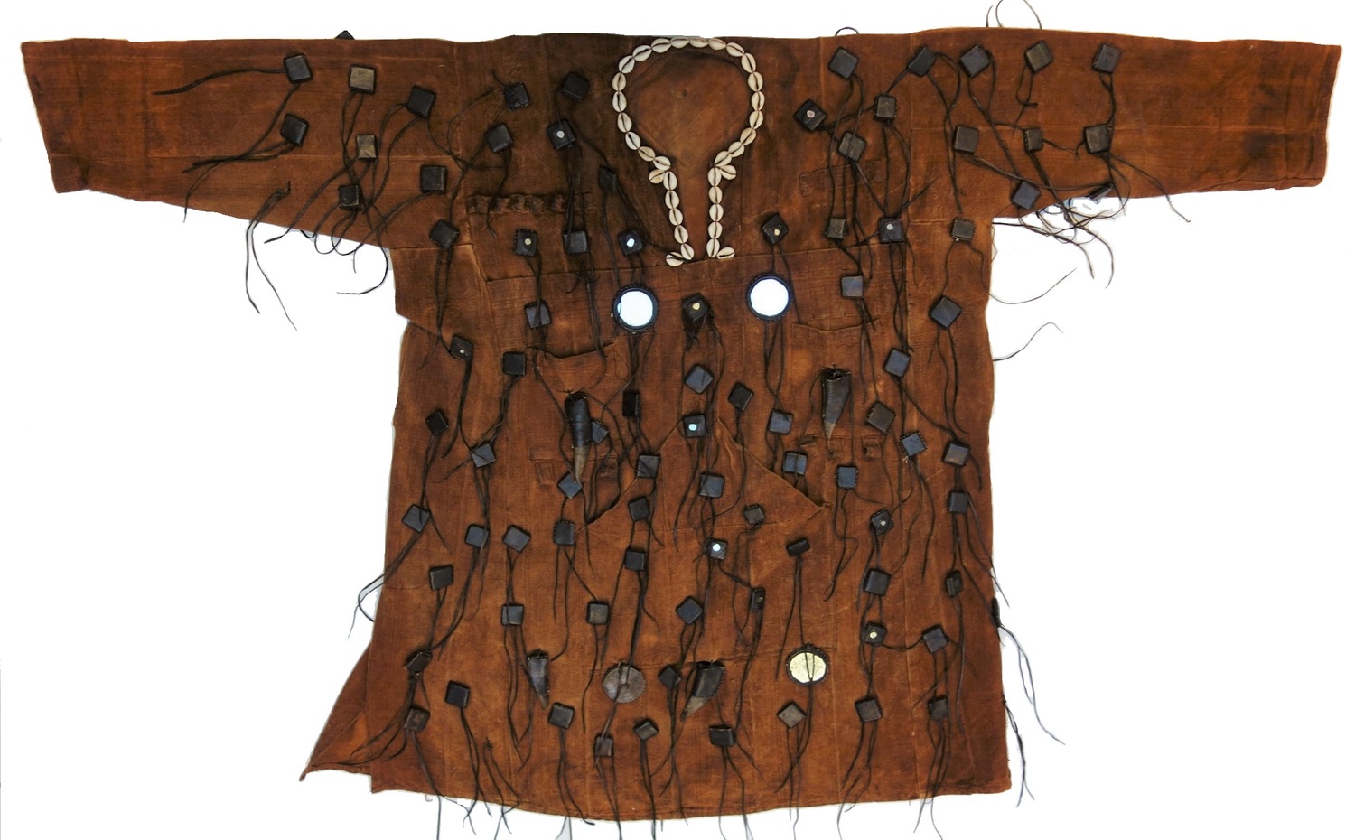 A brown longer sleeved tunic with cowrie shells around the edges of the neckline. It also has tassels and pieces of various items attached, including mirrors this time.