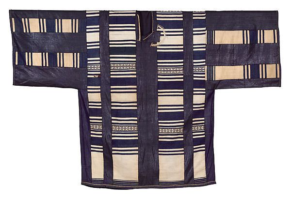 A wide sleeved tunic with black vertical and horizontal stripes, and light brown filling the rest of the space.