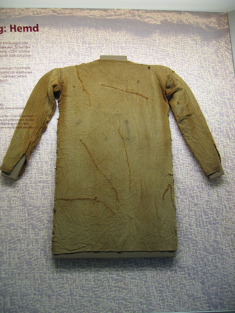 An image of a long sleeved greenish brown tunic with slits in the sleeves